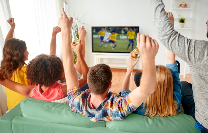 Pessoas assistindo futebol na tv